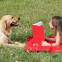 Girl and dog reading book